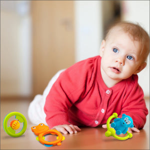 A kid playing with rattle set