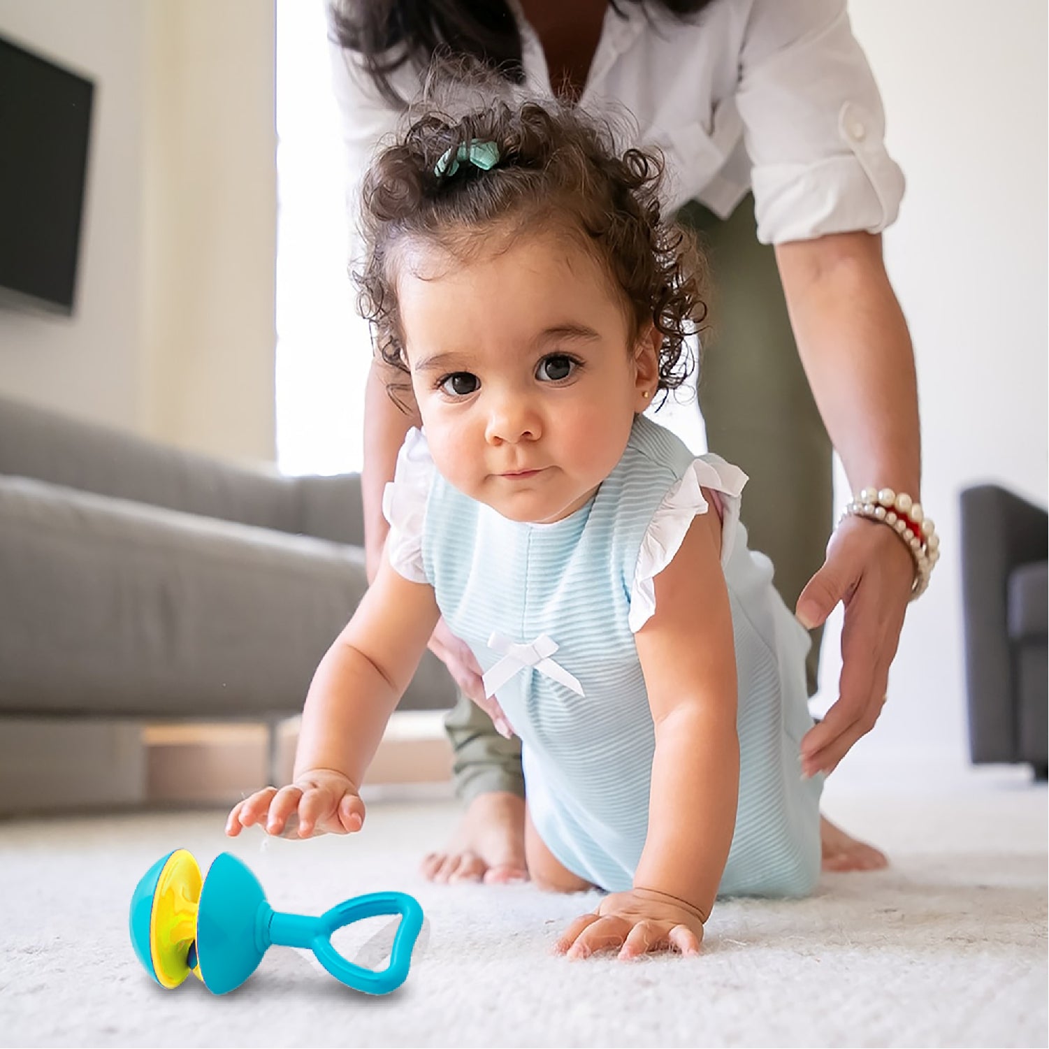 Kid Playing With Rattle Set