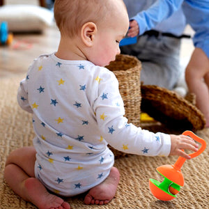 Kid Playing With Rattle Set